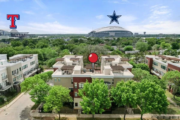 a view of a house with a yard and potted plants
