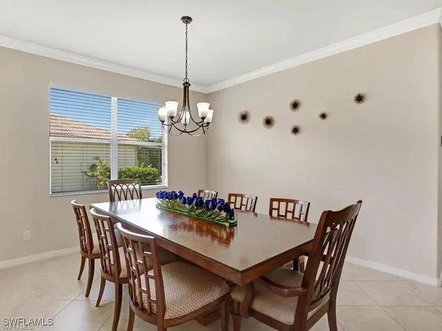 a view of a dining room with furniture a chandelier and wooden floor