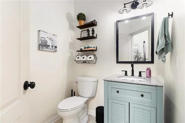 a bathroom with a toilet sink and mirror
