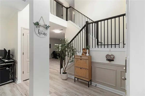 a view of entryway and hall with wooden floor