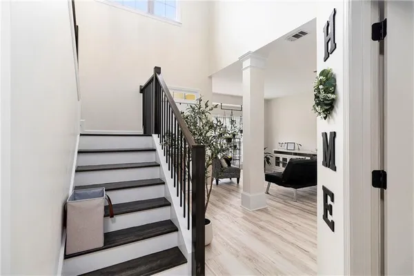 a view of staircase with wooden floor and chair