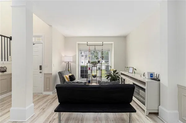 a room with a table chairs and wooden floor