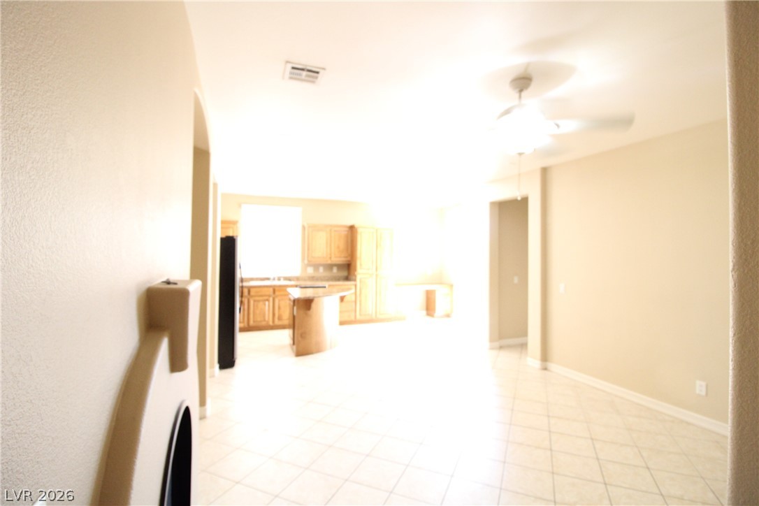 754 Rise Canyon Drive Henderson, NV 89052 - Photo 33 of 34 A versatile open floorplan featuring tile flooring seamlessly connecting the living area and kitchen.