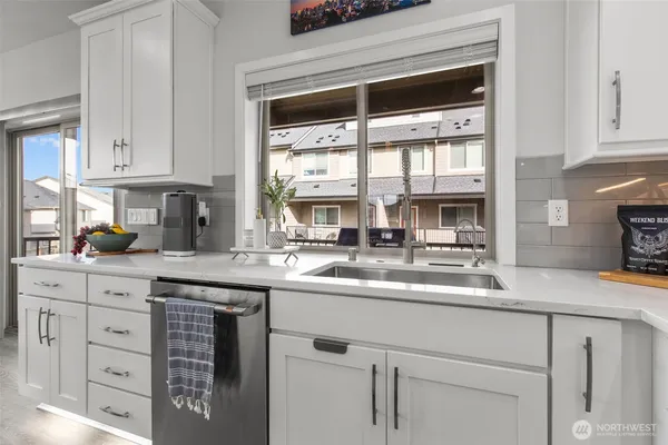a kitchen with cabinets appliances a sink and a window