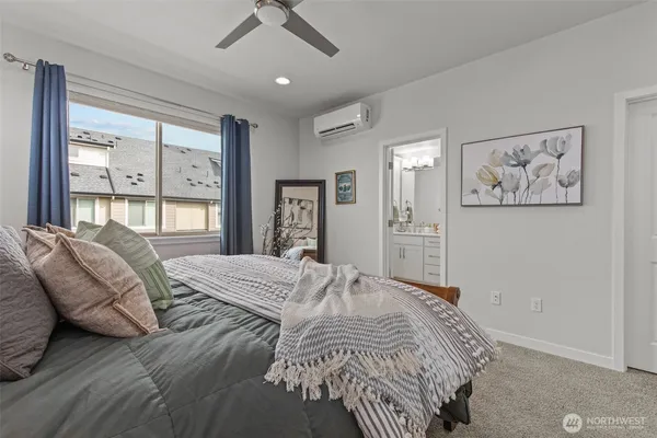 a bedroom with a large bed and a window