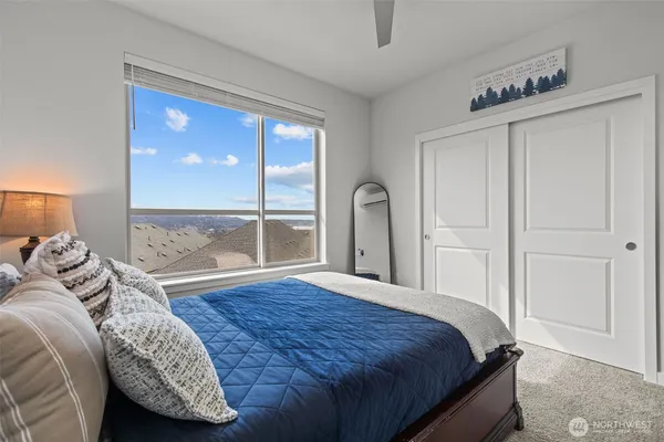 a bedroom with a large bed and a large window