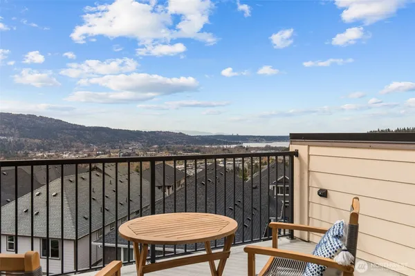 a view of a balcony with chair and wooden floor