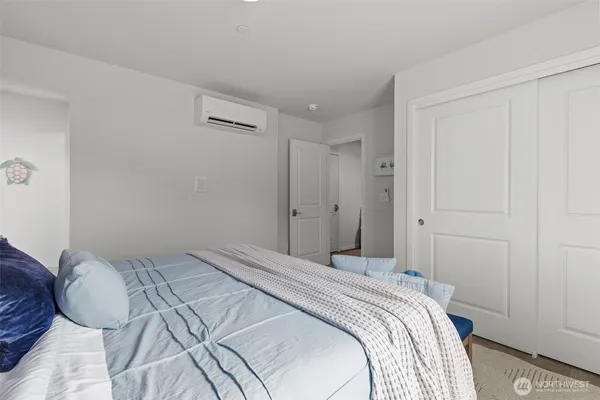 a bedroom with a bed and a closet
