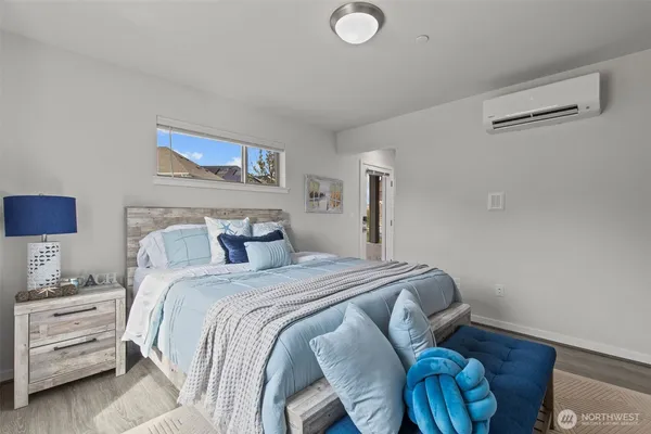 a bedroom with a bed and a lamp