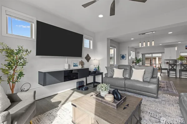 a living room with furniture a large window and a flat screen tv