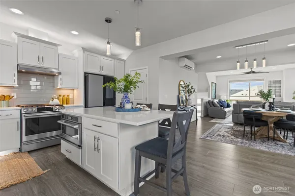 a kitchen with a table chairs sink and cabinets
