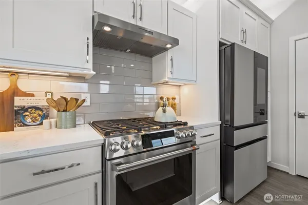 a stove top oven sitting inside of a kitchen