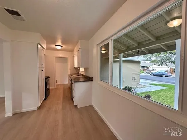 a view of a room with wooden floor and a porch