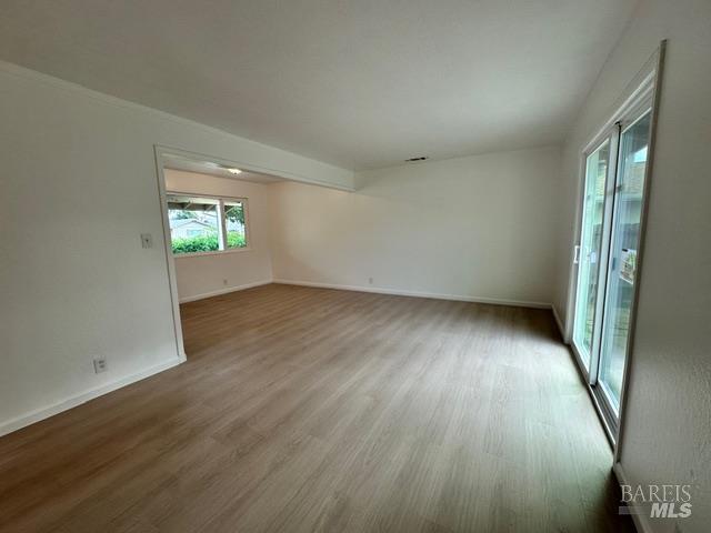 2119 Tipton Way Fairfield, CA 94533 - Photo 6 of 11 an empty room with wooden floor and windows