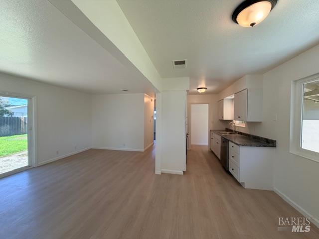 2119 Tipton Way Fairfield, CA 94533 - Photo 10 of 11 an empty room with wooden floor and windows