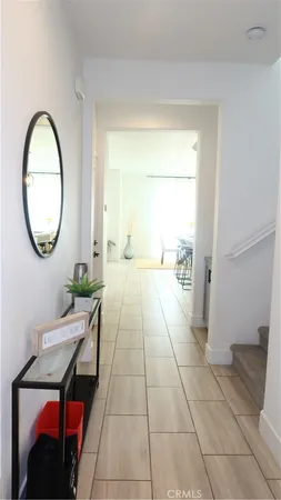 a living room with a mirror and a table