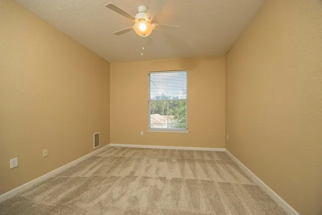 a view of building with swimming pool and green space