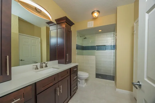 a bathroom with a double vanity sink and mirror