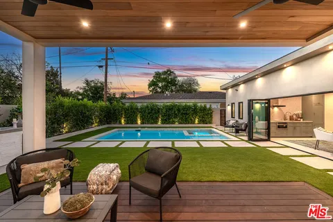 a view of swimming pool with outdoor seating and plants