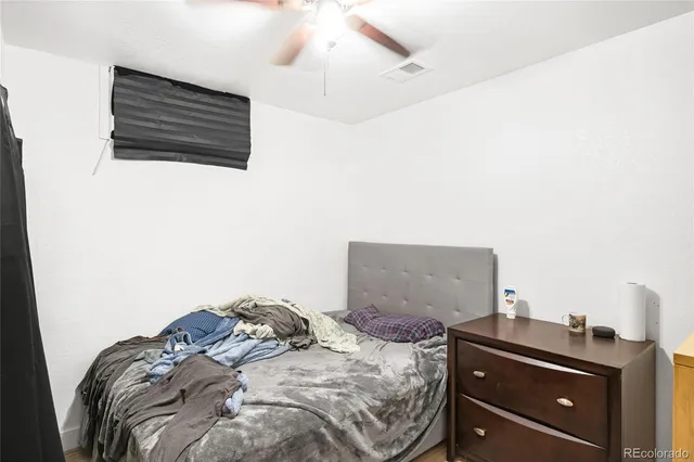 a bed sitting in a bedroom next to a window