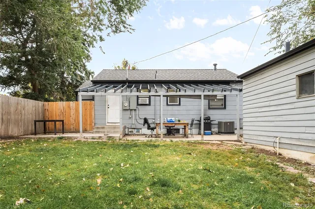 a backyard of a house with table and chairs