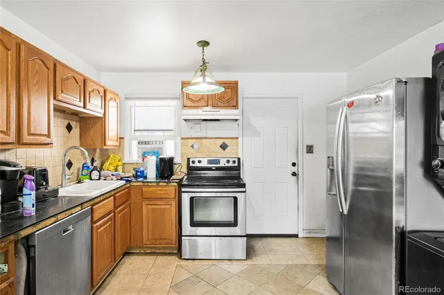 a kitchen with stainless steel appliances a refrigerator sink and cabinets