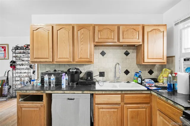 a kitchen with stainless steel appliances granite countertop a sink and cabinets