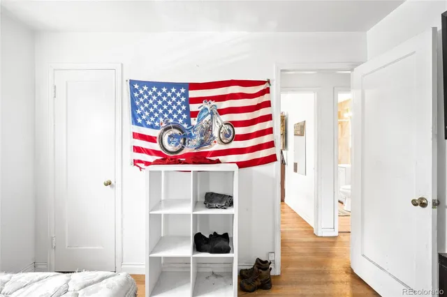 a view of a bedroom with clothes and shoes