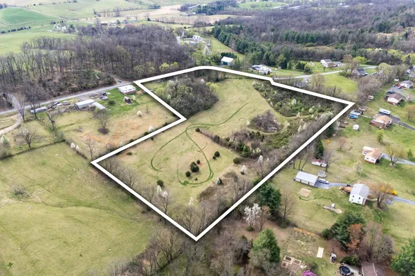 a view of swimming pool with a backyard and seating area