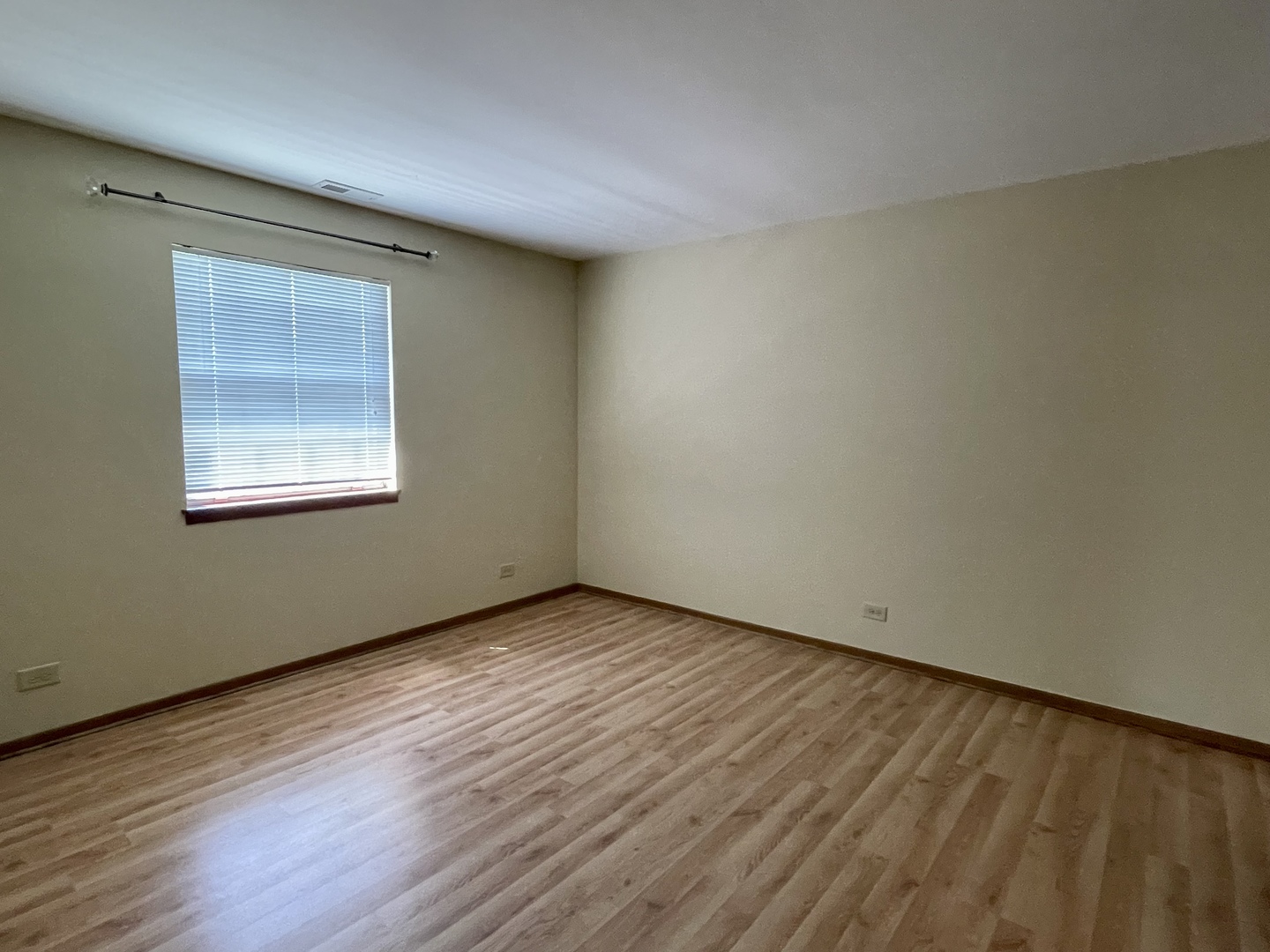 20 Gant Circle, Unit E Streamwood, IL 60107 - Photo 7 of 21 a view of an empty room with wooden floor and a window
