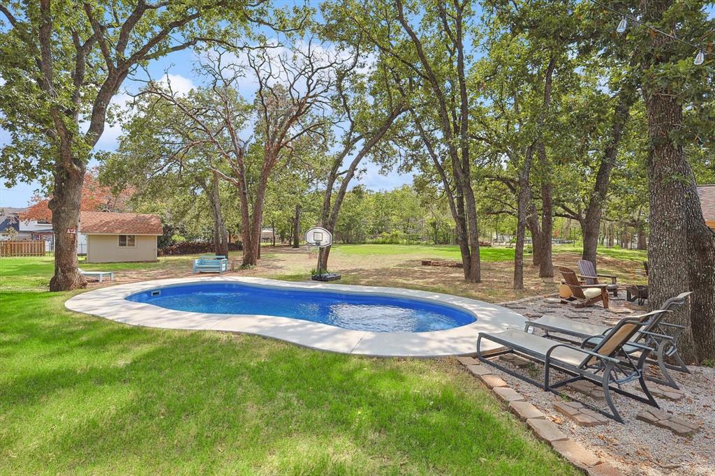 a view of a house with swimming pool and sitting area