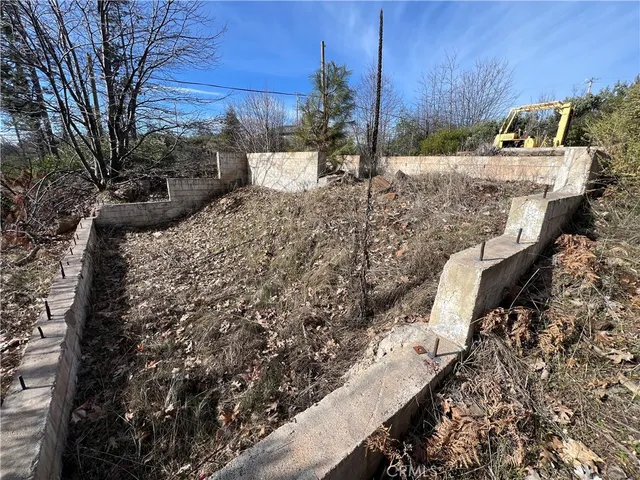 a view of a yard with wooden fence