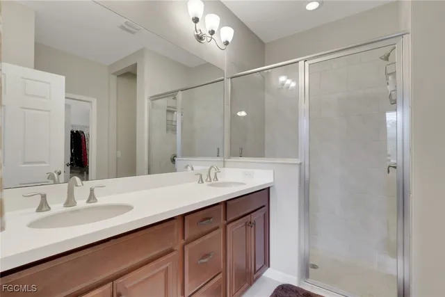 a bathroom with a sink double vanity and shower
