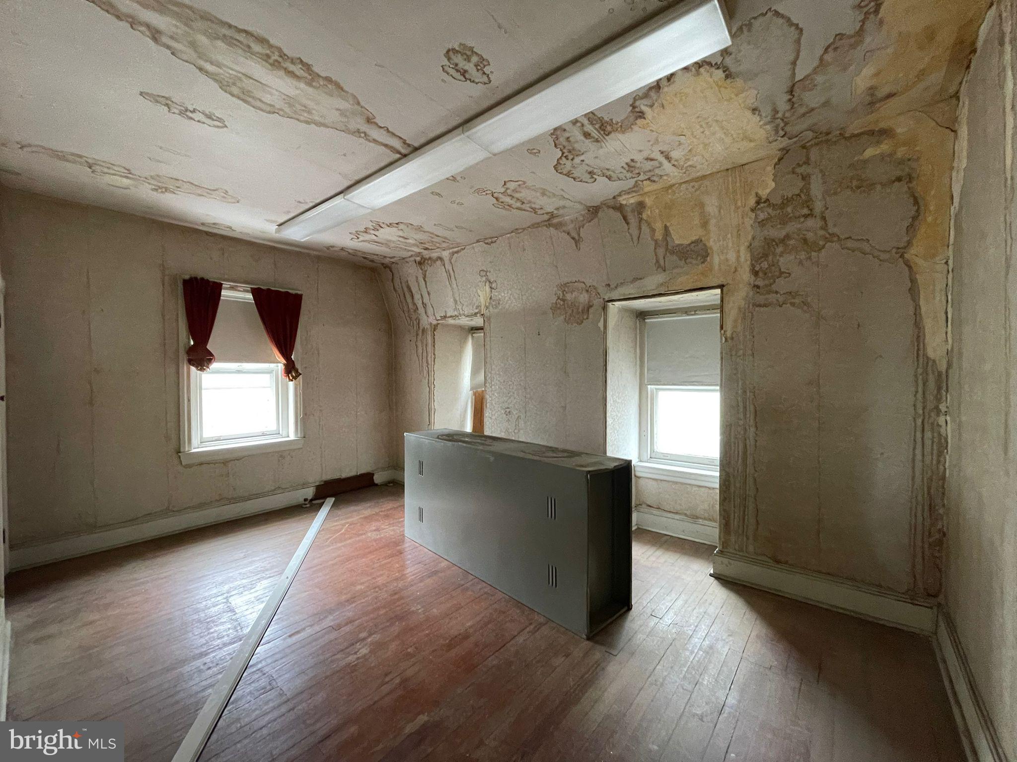 5809 Chew Avenue Philadelphia, PA 19138 - Photo 9 of 29 an empty room with wooden floor and windows