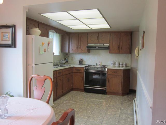 6061 Neola Road Stroudsburg, PA 18360 - Photo 3 of 26 a kitchen with stainless steel appliances granite countertop a refrigerator sink and stove