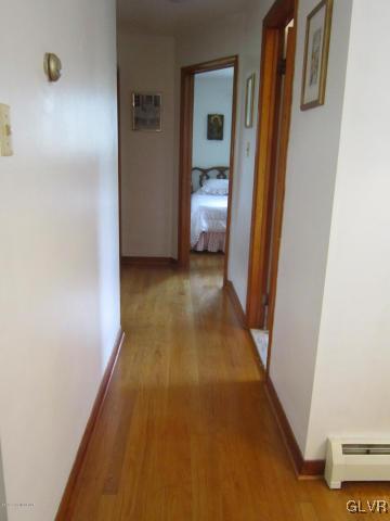 6061 Neola Road Stroudsburg, PA 18360 - Photo 10 of 26 a view of a hallway with wooden floor and a bathroom