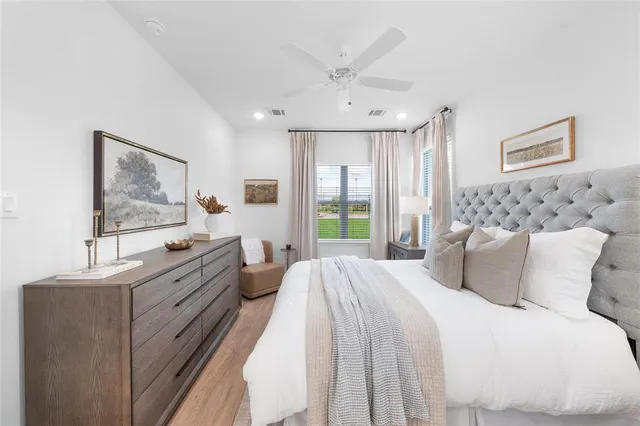 a bedroom with a large bed and a window