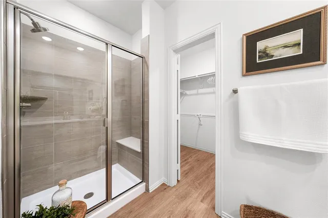 a bathroom with a glass shower door