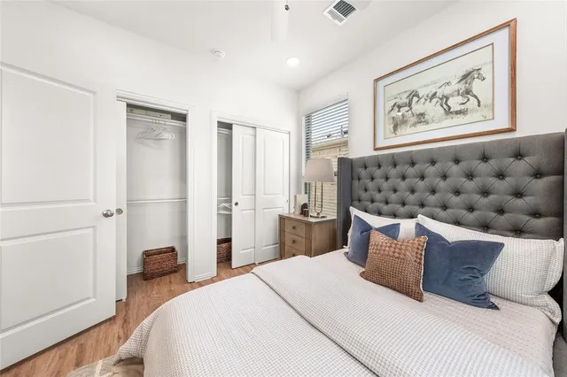 a bedroom with a bed and a painting on the wall