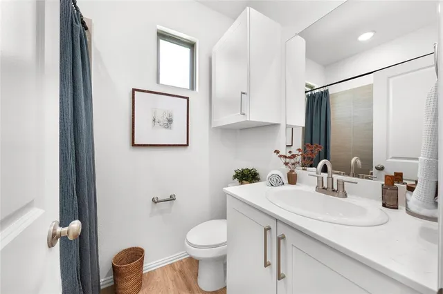 a bathroom with a sink toilet and vanity