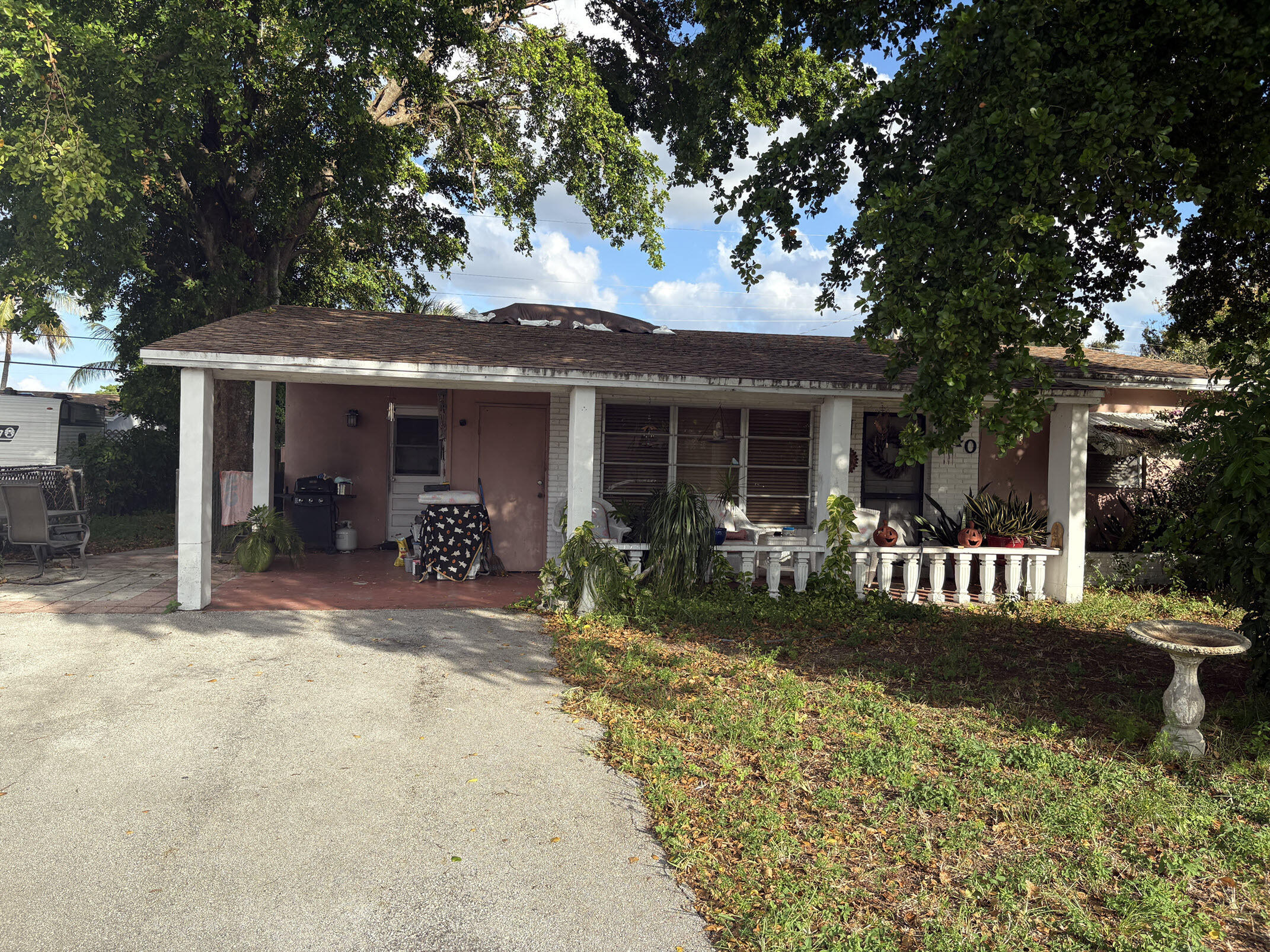a view of a house with backyard porch and sitting area