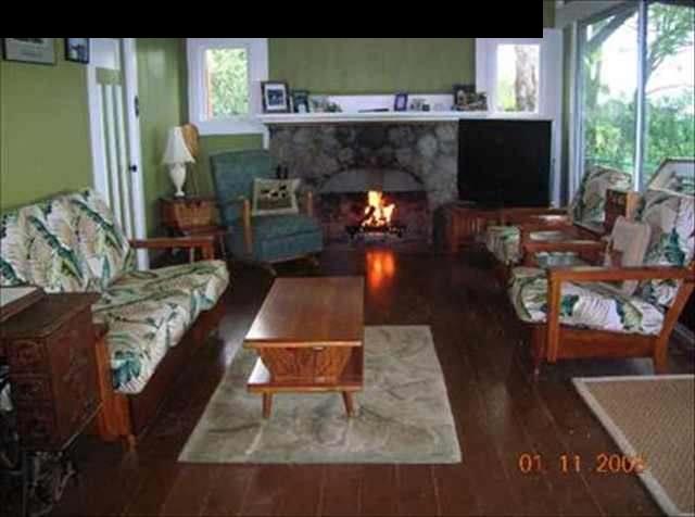 471 Pulehuiki Road Kula, HI 96790 - Photo 3 of 30 a living room with furniture and a fireplace
