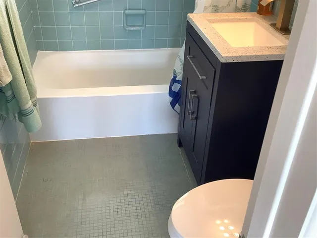 a bathroom with a tub sink and toilet