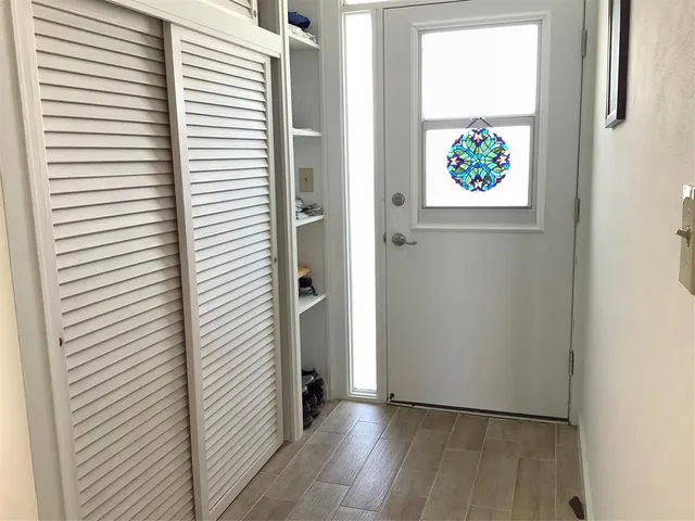a view of an entryway with wooden floor