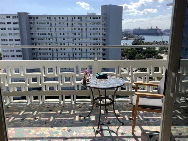 a view of a balcony with table and chairs