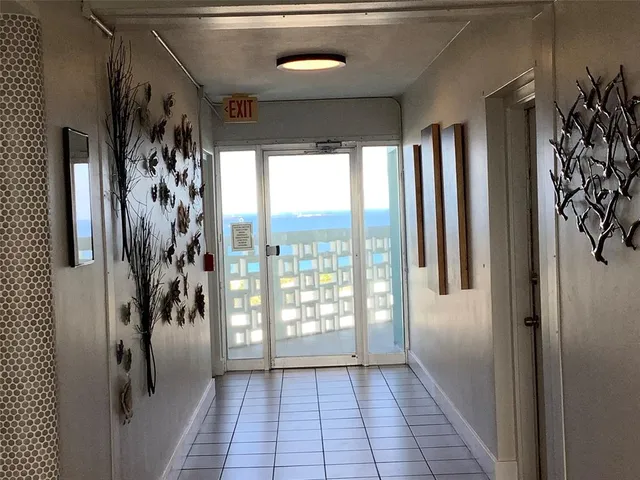 a view of a livingroom with wooden floor and furniture
