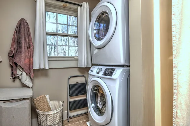 a bathroom with a granite countertop toilet sink and mirror