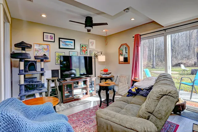 a kitchen with stainless steel appliances kitchen island granite countertop a table chairs and a refrigerator