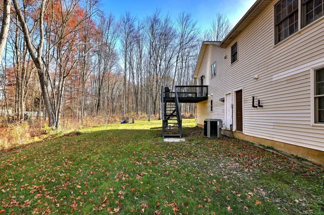 a view of a house with a backyard