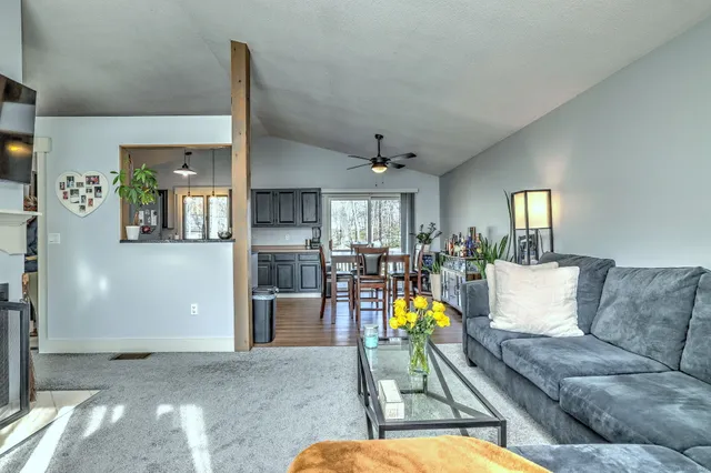 a living room with furniture and painting on the wall